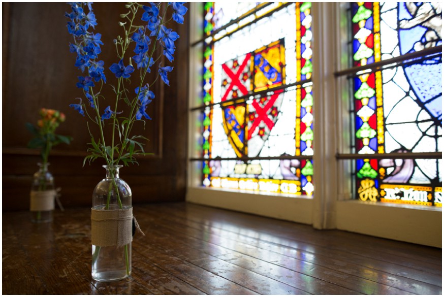 Rustic blue flower wedding decorations by stained glass window 