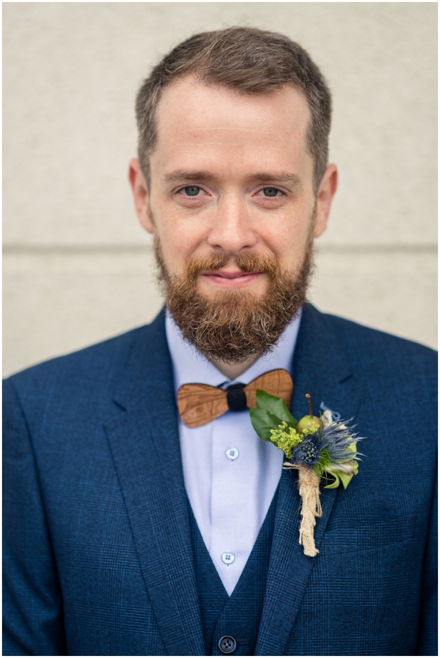 Groom in blue suit and unique bow tie