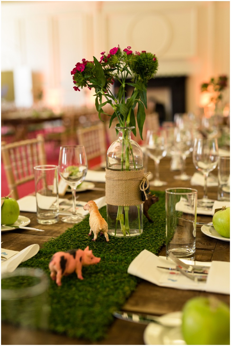 Farm themed centrepiece with green and pink flowers in vintage bottles
