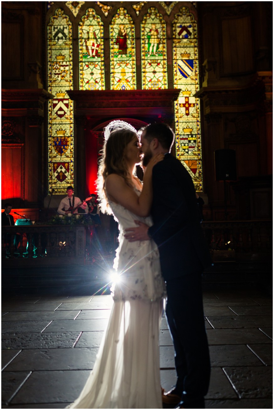 Bride and Groom first dance at wedding reception in front of stained glass windows 