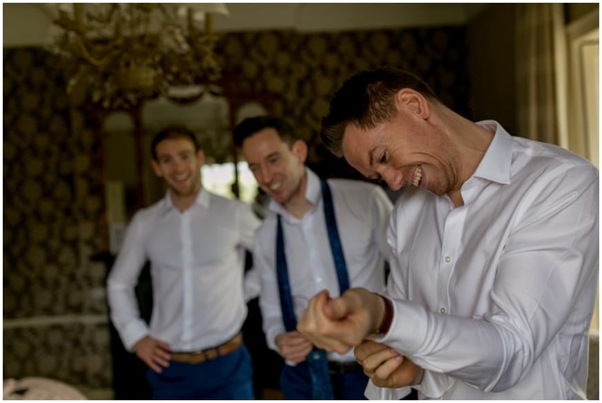 Groom getting ready with groomsmen in the morning