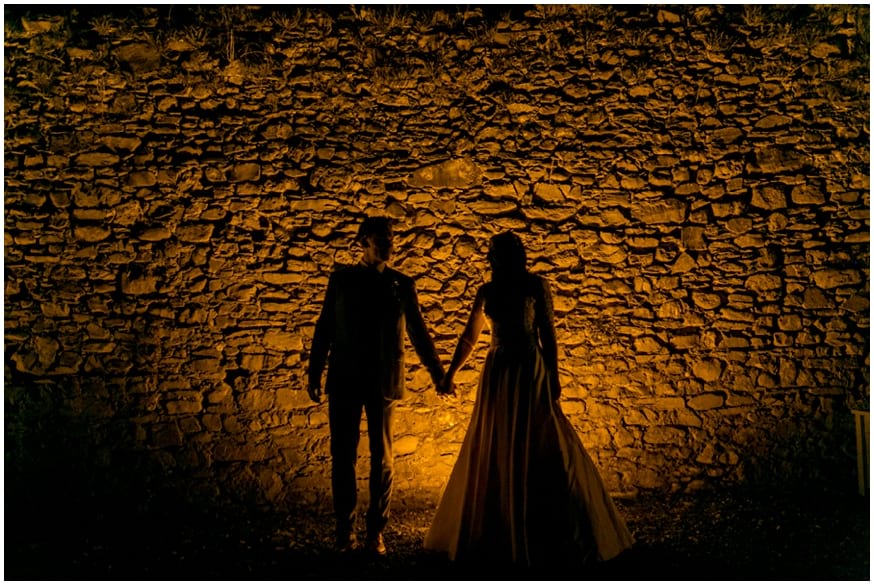 Bride and Groom hold hands silhouette