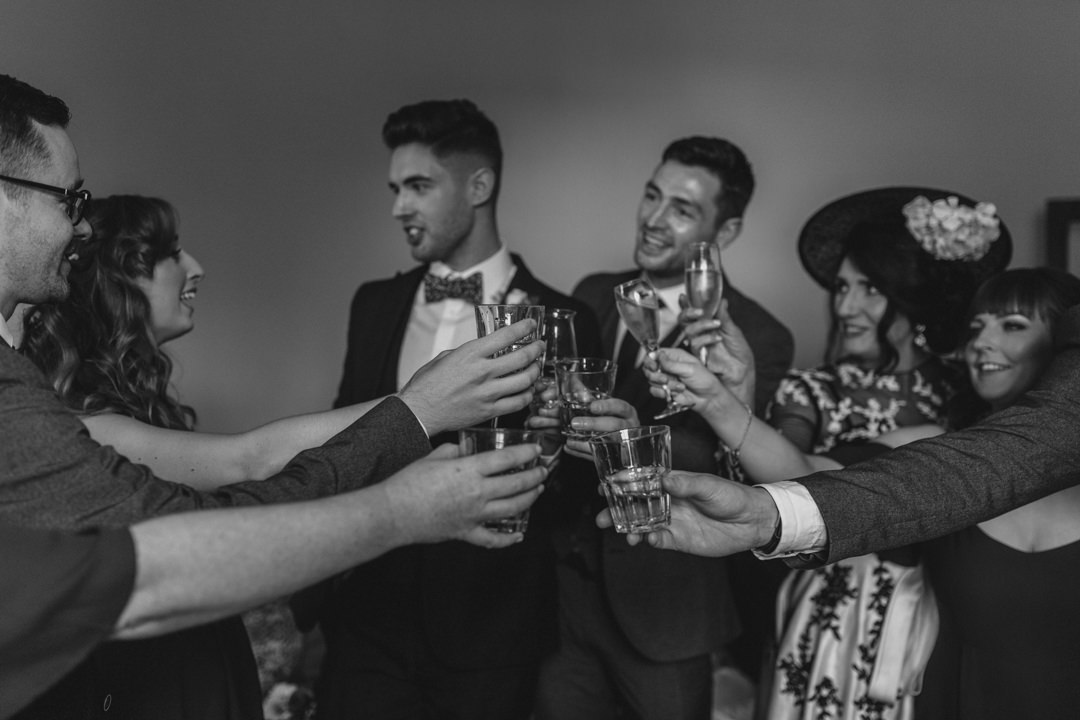 Bridal party cheers a drink before the ceremony 